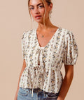 Floral smocked hem blouse with tie front detail styled casually with denim shorts