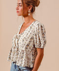 Floral smocked hem blouse with tie front detail styled with pearl drop earrings