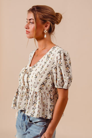 Floral smocked hem blouse with tie front detail styled with pearl drop earrings