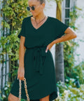 Model wearing green tie-waist mini dress front view 
