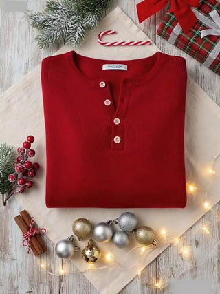 Folded red knit top showing half button placket detail