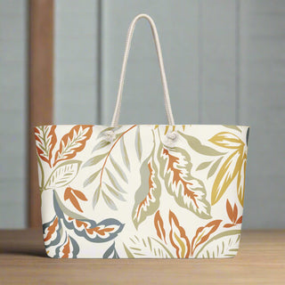 Autumn leaf print tote bag placed on wooden floor with soft lighting