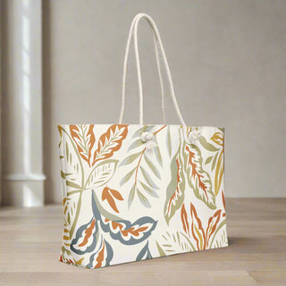 Side view of large tote bag featuring autumn-inspired leaf design on cream background