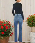 Back view of high rise jeans showing yoke detail and raw hem