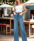 Front view of high rise wide leg jeans styled with casual top