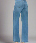 Full length view of high rise wide leg jeans in studio lighting