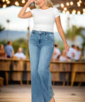 Woman wearing high rise wide leg jeans with flare hem walking outdoors