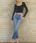 Woman wearing high rise wide waistband jeans with raw hem