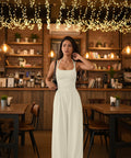Ivory spaghetti strap wide leg jumpsuit styled for vacations, bridal events, and summer celebrations.