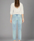 Back view of cropped light wash jeans with clean pocket detail