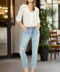 Side view of relaxed fit light denim jeans with ankle crop