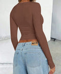 Back view of brown fitted long sleeve top