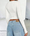 Back view of white fitted long sleeve top
