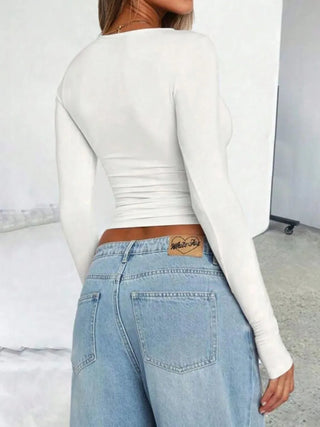 Back view of white fitted long sleeve top