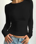 Woman wearing black fitted long sleeve top