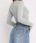 Side view of gray fitted long sleeve top