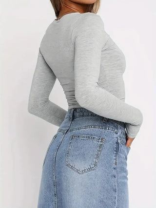 Side view of gray fitted long sleeve top