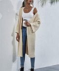 Woman wearing a chunky knit cardigan in front view
