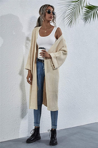 Woman wearing a chunky knit cardigan in front view
