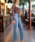 Straight cut vintage wash jeans styled with long sleeve top and heels