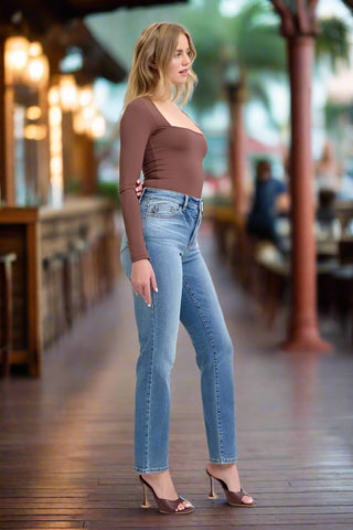 Straight cut vintage wash jeans styled with long sleeve top and heels