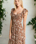 Woman wearing mocha floral tiered maxi dress with ruffle sleeves and sweetheart neckline