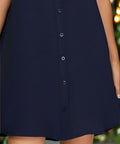 Close-up of button down front on navy woven shirt dress