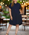 Woman walking in navy shirt dress styled with heels