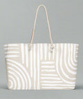 Minimalist swirl print tote with rope handles on flat background