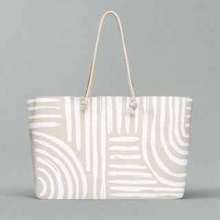Minimalist swirl print tote with rope handles on flat background