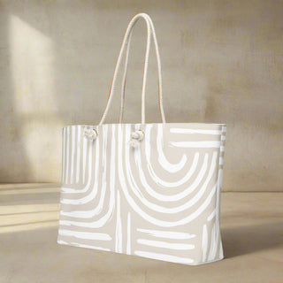 Side angle of large neutral printed weekender tote with soft rope handles