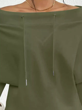Close-up of olive off-shoulder neckline and drawstring detail
