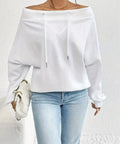 White off-shoulder spring top styled casually with light wash jeans