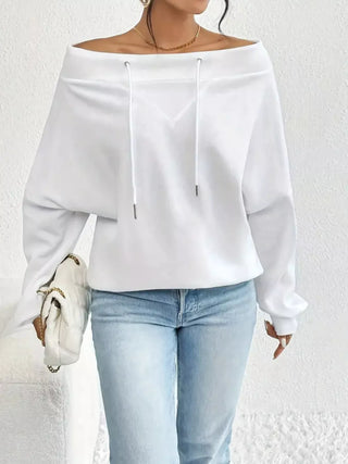 White off-shoulder spring top styled casually with light wash jeans