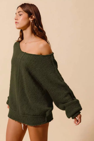 Angled view of olive slouchy off-shoulder bouclé sweater for women