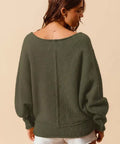Back view of loose fit olive exposed seam bouclé sweater