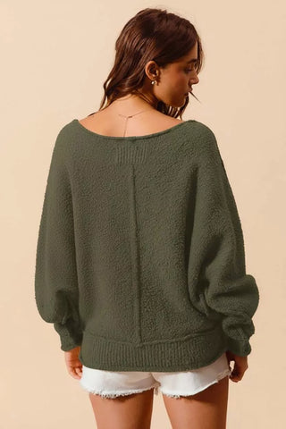 Back view of loose fit olive exposed seam bouclé sweater