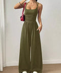 Olive green spaghetti strap wide leg jumpsuit styled for casual vacations and weekend outings.