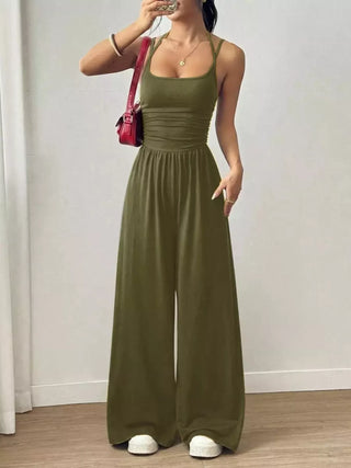 Olive green spaghetti strap wide leg jumpsuit styled for casual vacations and weekend outings.