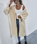 Model posing with hands in cardigan pockets