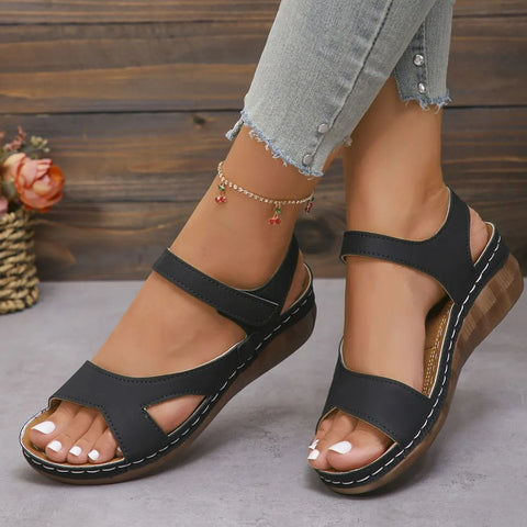 Woman wearing black open toe platform sandals with cushioned sole