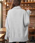 Back view of gray oversized turtleneck sweater