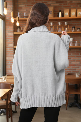Back view of gray oversized turtleneck sweater