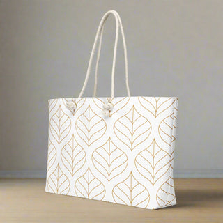 Angled side view of weekender tote bag with gold leaf pattern