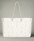  Front view of oversized weekender tote with gold leaf print and rope handles