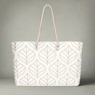  Front view of oversized weekender tote with gold leaf print and rope handles