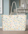 Weekender tote bag with pastel triangles placed on wooden table