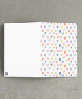 Back view of pastel hearts greeting card showing blank interior for personal message