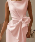 pink wedding guest midi dress featuring oversized bow detail and side slit