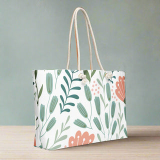 Side angle of large floral print weekender tote bag with rope handles
